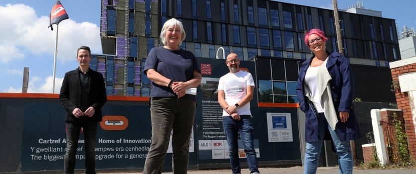 Professor Sally Power pictured in front of sbarc I spark building alongside other Cardiff University colleagues