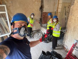 Selfie of group of construction workers onsite wearing masks