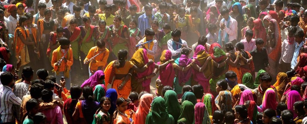 Adivasi youths dancing during colourful Bhagoriya festival on a market day in Bakhatgarh.