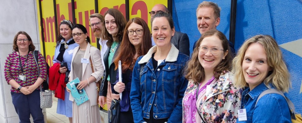 Pictured left to right: Catherine Marston (WHEB), Lelia Toma, Annie Tubadji, Ian Thomas, Alexandra Sandu, Rhian Barrance, Nick Hacking, Sioned Pearce, Robin Mann, Flossie Caerwynt and Catrin Wyn Edwards (WISERD) in front of a brightly coloured wall in Brussels