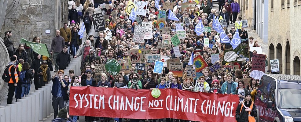 Protesters walking down hill at COP27 Edinburgh march