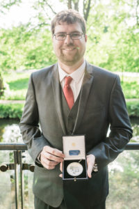 Stuart Fox holding his LSW Dillwyn medal