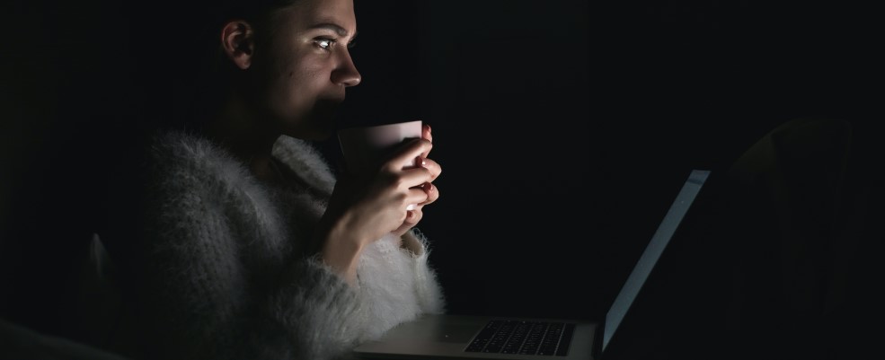 Person using laptop in dark