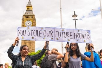 Young female students protest against Brexit in front of the House of Parliament in London