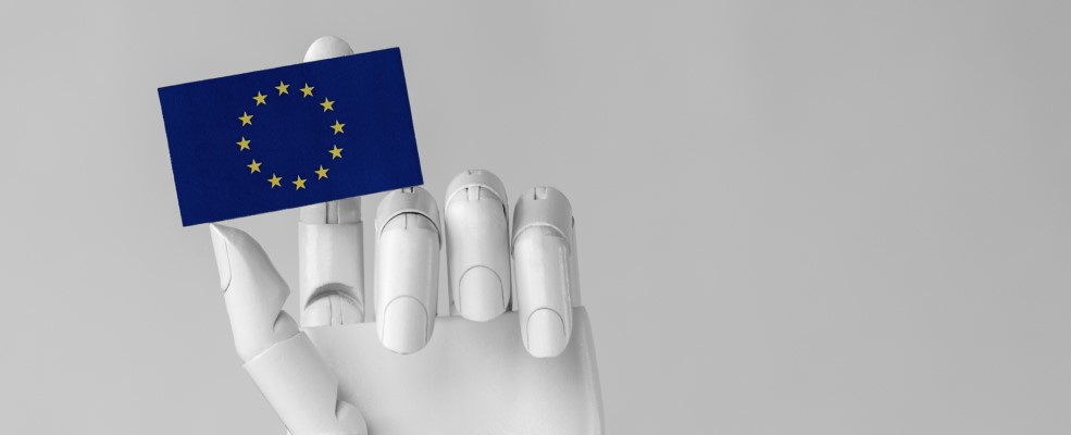 Robot hand holding EU flag.